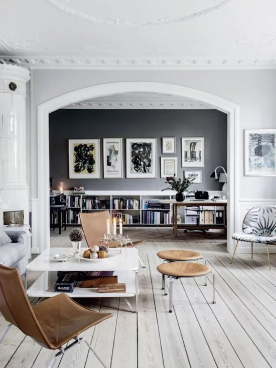 grauer Boden Wohnzimmer offener raum niedrige Möbel Akzente in Schokoladenbraun Hocker Stühle schöne Wandbilder