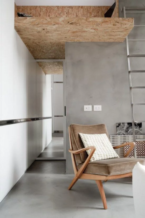 grauer Boden aus Beton minimalistischer Raum Holz Sessel