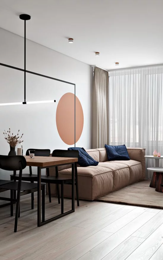 Mehr Farbe ins Interieur schicke Sitzecke im offenen Raum Wandtupfer warmes Orange Sofa in Hellbraun schickes Gestaltungskonzept