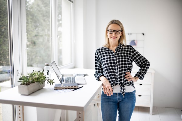 Woman,Working,At,A,Standing,Desk,In,Office