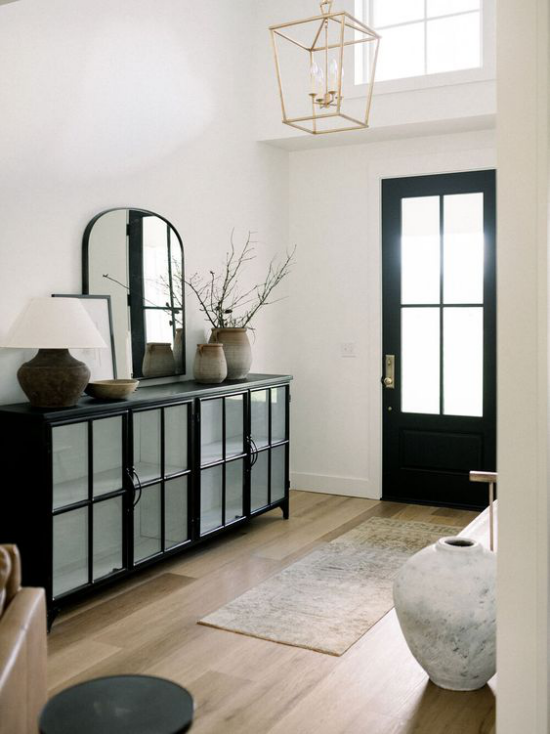 Farbpaare Flur Eingangsbereich in Schwarz und Weiß plus Pastellfarben Läufer schwarze Kommode weiße Wände Vase