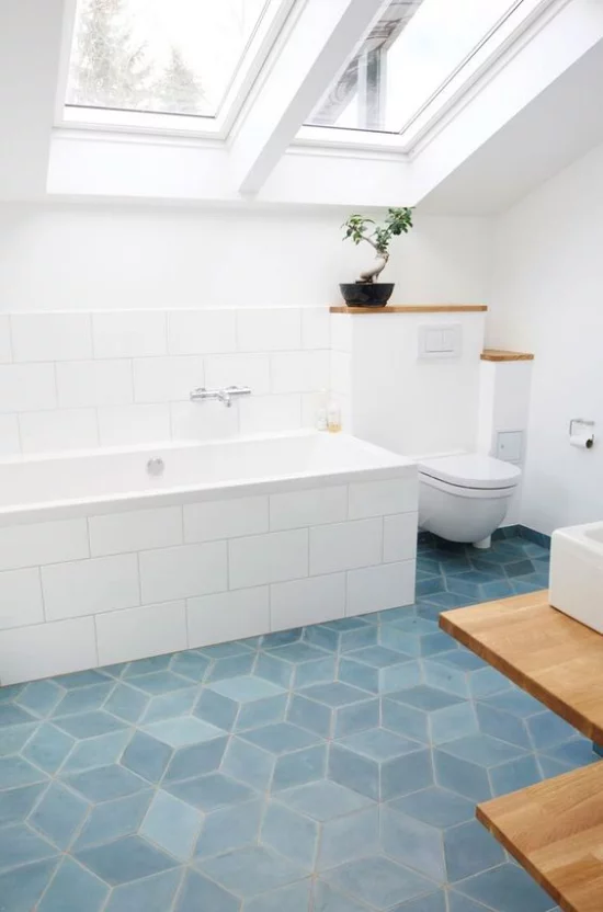 Moderne Dachfenster schicke Badgestaltung hellblaue Bodenfliesen weiße Badewanne viel Tageslicht