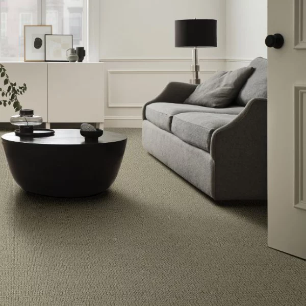 Evergreen Fog Farbe des Jahres 2022 modernes Interieur Teppichboden Sofa im Grau runder Tisch heller Wohnraum
