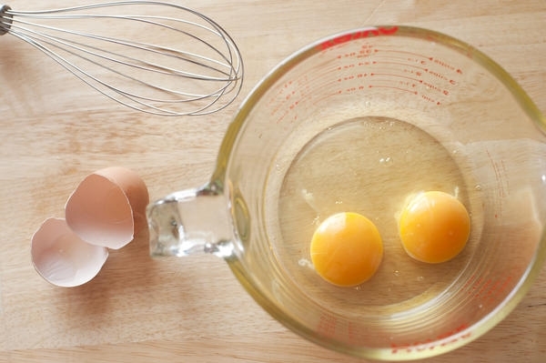 Two eggs in a mixing bowl