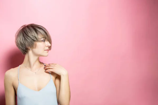 kurzer Bob Trendfrisur 2022 für mutige Frauen aschblondes Haar zur Seite geföhnt