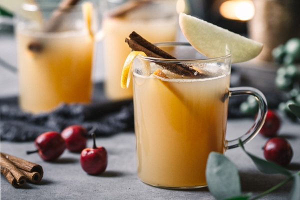 Warme Winter-Drinks heißer Apfelsaft mit Zimtstange Schuss Gin Apfelscheibe wärmt auf schmeckt hervorragend