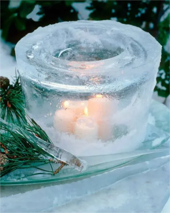Gefrorene Weihnachtsdeko draussen runde Form einige Teelichter darin im Eis brennen