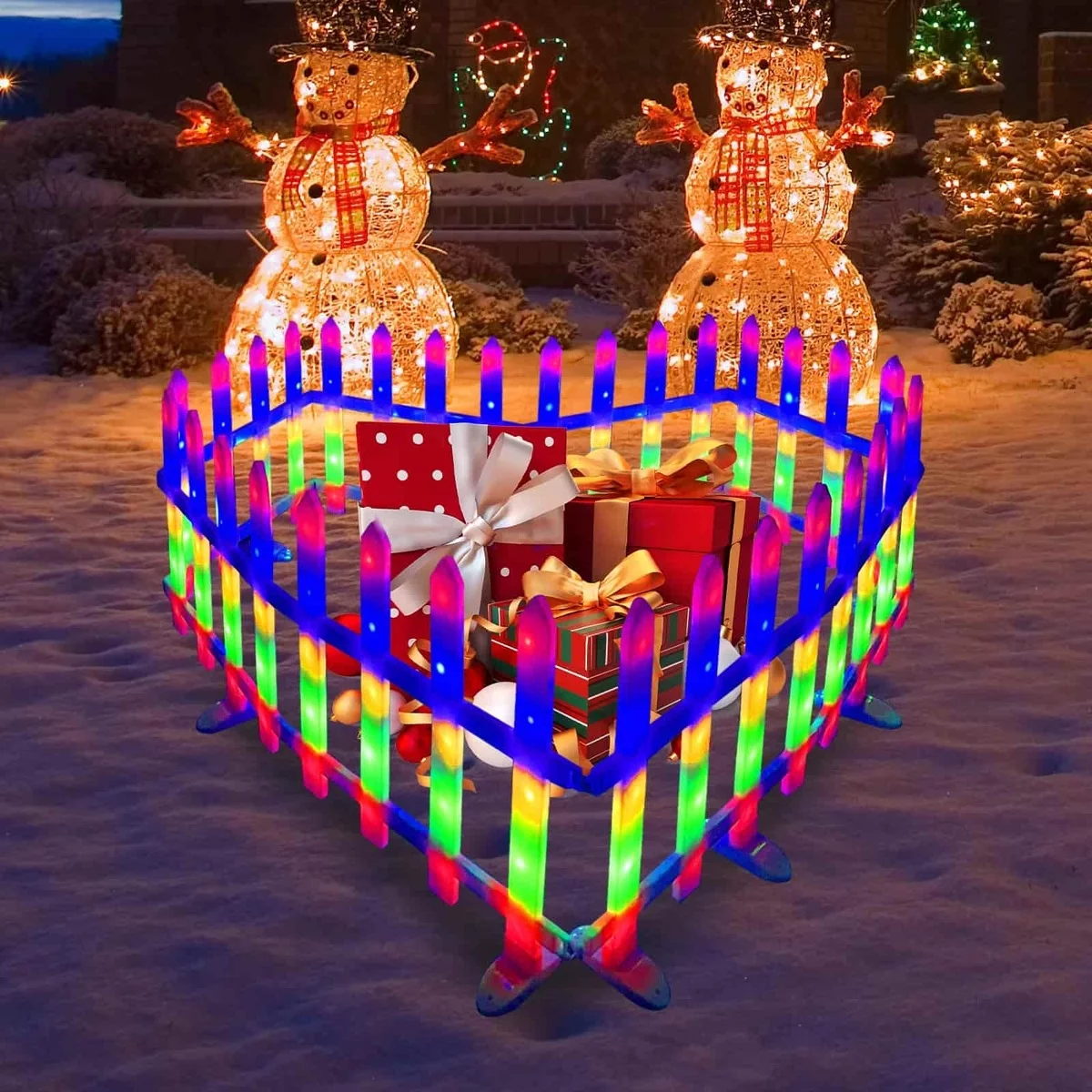 niedliche Weihnachtsdeko im Garten mit zwei leuchtenden Schneemännern