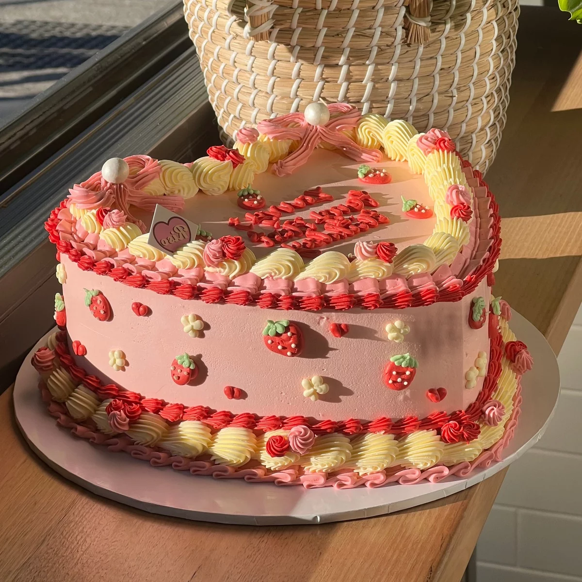 ein prächtig dekorierter Erdbeerkuchen in Herzform 