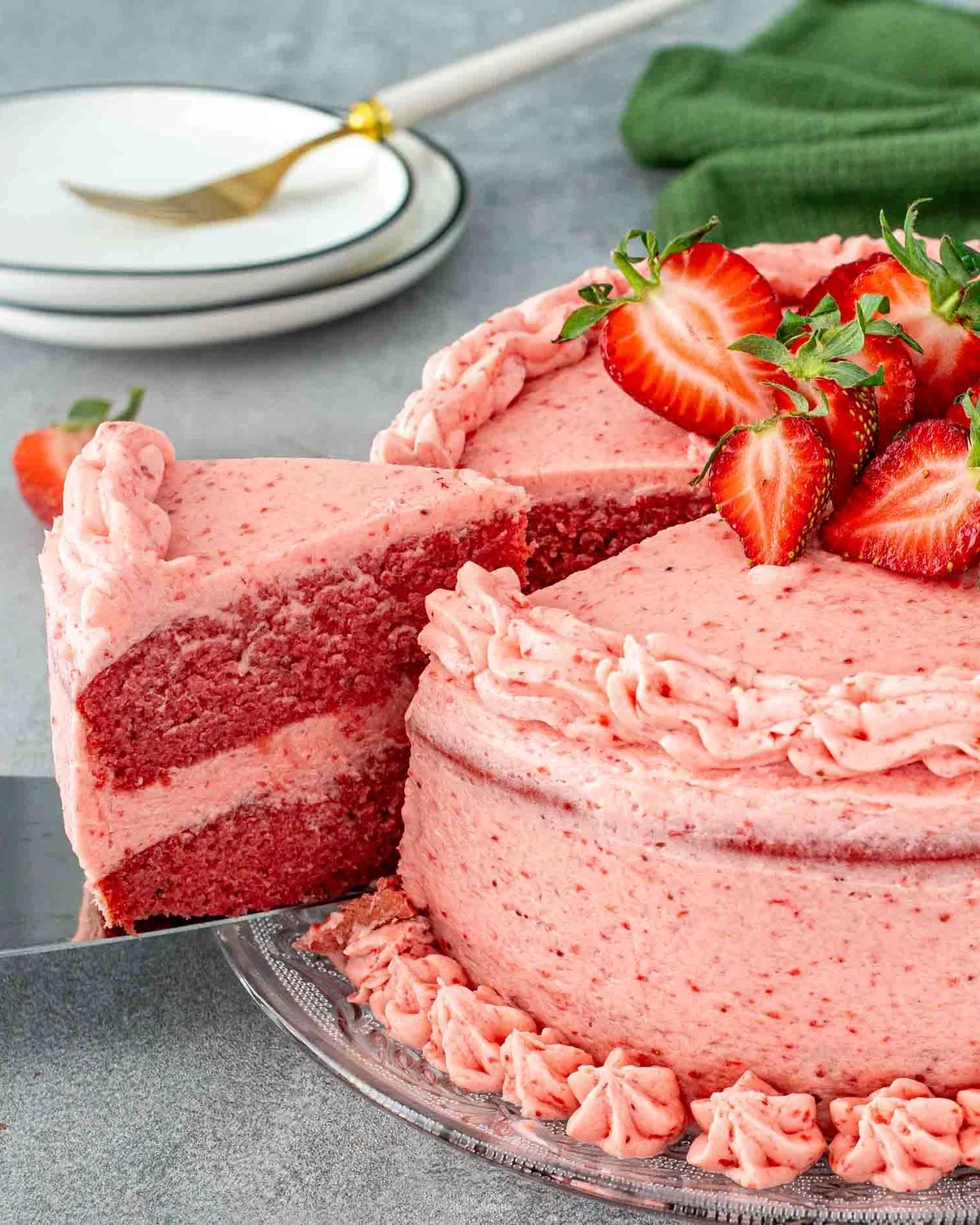 ein Stück vom rosa Erdbeerkuchen mit frischen Früchten dekoriert 