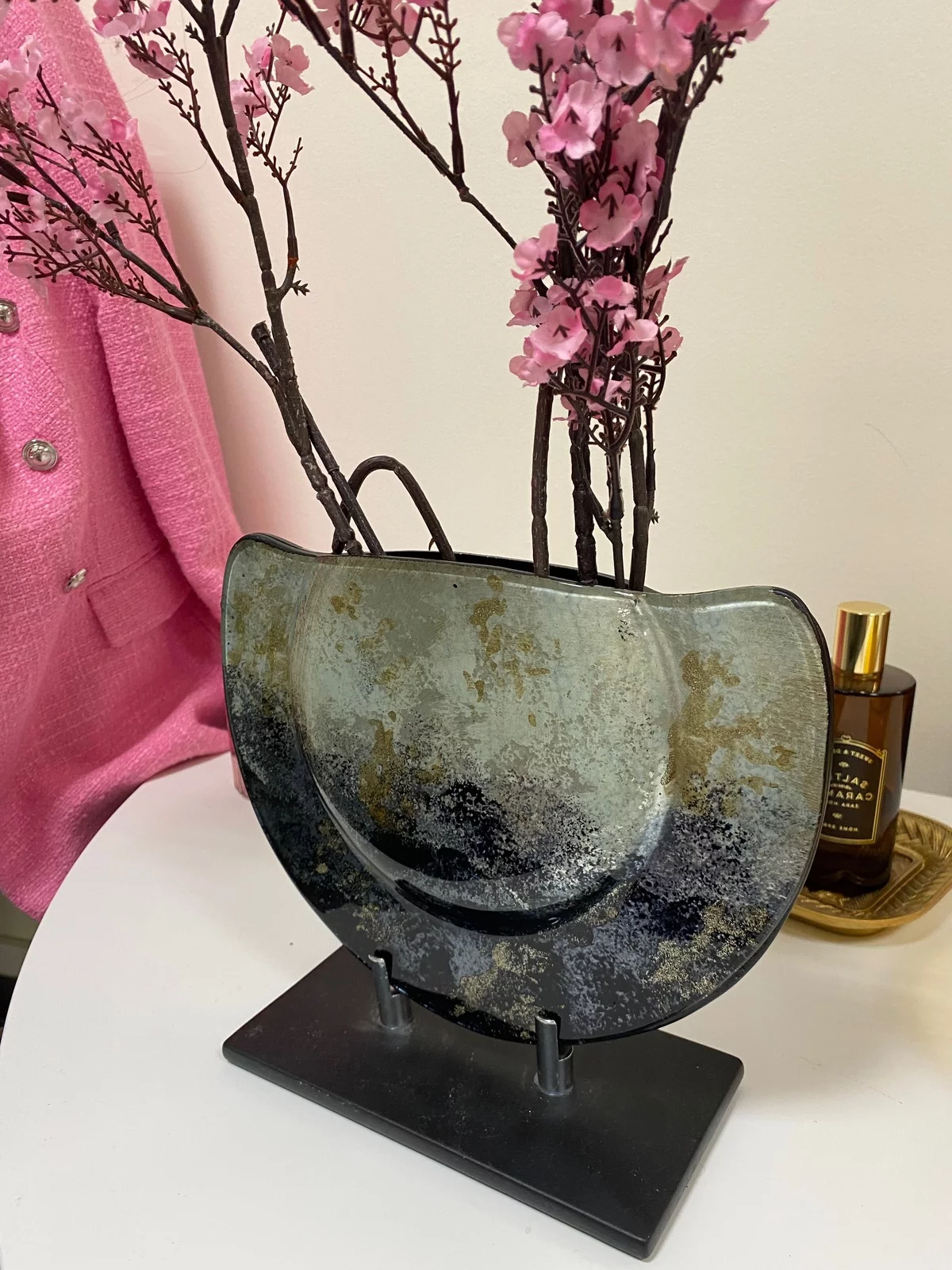 künstliche rosa Blüten auf Zweigen in einer Vase arrangiert