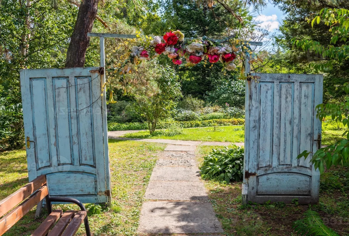 Garten Upcycling Ideen- alte Holztüren im Garten eingesetzt und bilden Rosenbogen 