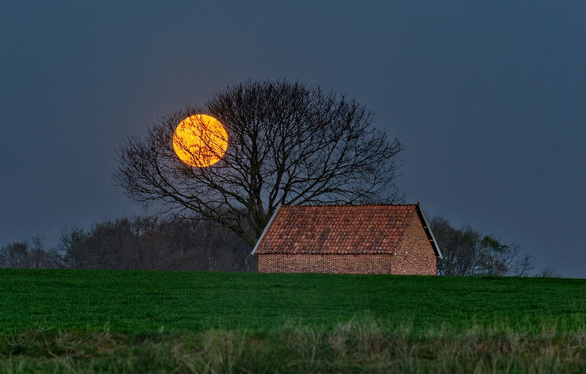 Erntemond im Oktober über einer grünen Landschaft